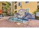 Inviting hot tub area featuring a tiled spa with a decorative fountain, surrounded by lush landscaping at 1910 E Palm Ave # 10301, Tampa, FL 33605