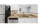 Bright kitchen featuring granite countertops, stainless steel appliances, and white cabinetry at 1910 E Palm Ave # 10301, Tampa, FL 33605