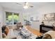 Sunlit living room with hardwood floors, comfortable seating, ceiling fan, and open layout at 1910 E Palm Ave # 10301, Tampa, FL 33605