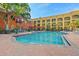 Large swimming pool with clear water and ample seating, set against a backdrop of well-maintained apartment buildings at 1910 E Palm Ave # 10301, Tampa, FL 33605