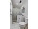 Bathroom featuring a step in shower with glass doors, sink, mirror, and a toilet at 211 S Obrien St, Tampa, FL 33609