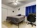 Bedroom with a ceiling fan, window, closet, and a black gaming chair in front of a computer at 211 S Obrien St, Tampa, FL 33609