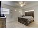 Bedroom with a ceiling fan, window, and a dresser with a mounted TV on top of the dresser at 211 S Obrien St, Tampa, FL 33609