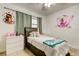 Bedroom with a ceiling fan, window, and butterfly and princess wall decals at 211 S Obrien St, Tampa, FL 33609