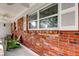 Exterior elevation of home showcasing large windows, brickwork, and open porch at 211 S Obrien St, Tampa, FL 33609