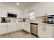 Modern kitchen with stainless steel appliances, white cabinets, and stylish backsplash at 211 S Obrien St, Tampa, FL 33609