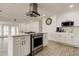 Kitchen with stainless oven and microwave and white cabinets that overlooks the living room and dining area at 211 S Obrien St, Tampa, FL 33609