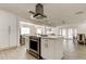 Kitchen with stainless oven, white cabinets, and an island that overlooks the living room and dining area at 211 S Obrien St, Tampa, FL 33609