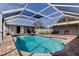 This screened-in pool features brick pavers and a jacuzzi at 211 S Obrien St, Tampa, FL 33609