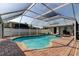 Relax by this screened-in pool that features brick pavers and a jacuzzi at 211 S Obrien St, Tampa, FL 33609