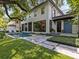 Beautiful backyard with a sparkling pool, lush landscaping, and a spacious patio area for entertaining at 2603 W Parkland Blvd, Tampa, FL 33609