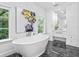 Bright bathroom with a soaking tub, black marble floor, and a modern vanity at 2603 W Parkland Blvd, Tampa, FL 33609