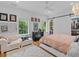 Bright bedroom features herringbone floors, a barn door closet, and windows overlooking lush greenery at 2603 W Parkland Blvd, Tampa, FL 33609