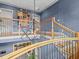 Elegant staircase with wooden railings, metal balusters, and a modern light fixture at 2603 W Parkland Blvd, Tampa, FL 33609
