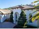 Stunning home exterior featuring a clay tile roof, arched entryway, and manicured landscaping at 2607 Hawks Landing Blvd, Palm Harbor, FL 34685