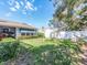 Backyard featuring a well-manicured lawn, privacy fence, and mature hedges at 2893 Turtle Ter, Palm Harbor, FL 34683