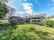 Well-maintained backyard with green lawn, mature trees, and tidy landscaping offering a private outdoor retreat at 2893 Turtle Ter, Palm Harbor, FL 34683