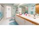 Light-filled bathroom with double sinks, a toilet, and an enclosed shower at 2893 Turtle Ter, Palm Harbor, FL 34683