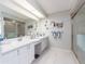 Bright bathroom with double sink vanity, shower, and decorative mirrors at 2893 Turtle Ter, Palm Harbor, FL 34683