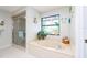 Bathroom featuring a soaking tub with a decorative stained glass window at 2893 Turtle Ter, Palm Harbor, FL 34683