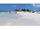Beautiful beach scene with clear waters, white sand, and people enjoying the sunshine at 2893 Turtle Ter, Palm Harbor, FL 34683