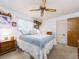 Cozy bedroom with a ceiling fan and comfortable bed with decorative pillows at 2893 Turtle Ter, Palm Harbor, FL 34683