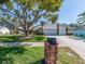 Charming single-Gathering home with a well-maintained lawn, mature tree, brick mailbox, and a two-car garage at 2893 Turtle Ter, Palm Harbor, FL 34683