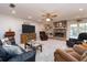 Cozy living room with brick fireplace, built-in shelving, and comfortable seating area at 2893 Turtle Ter, Palm Harbor, FL 34683