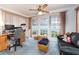 Well-lit office space with a desk, chair, and sofa, complemented by natural light from the windows at 2893 Turtle Ter, Palm Harbor, FL 34683