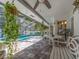 Screened patio with a pool and patio seating and hanging plants at 2893 Turtle Ter, Palm Harbor, FL 34683
