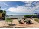 Charming backyard patio with stone benches and tables, overlooking the tranquil bay waters at 2901 Pelham Rd N, St Petersburg, FL 33710