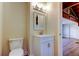 A small bathroom featuring a toilet and a sink with a vanity and modern lighting at 2901 Pelham Rd N, St Petersburg, FL 33710