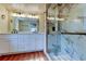 Elegant bathroom features a double vanity with marble countertops and a glass-enclosed marble shower at 2901 Pelham Rd N, St Petersburg, FL 33710