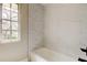 Tiled bathtub and shower combination in a well-lit renovated bathroom at 2901 Pelham Rd N, St Petersburg, FL 33710