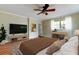Comfortable main bedroom featuring a TV, stylish decor, and a cozy seating area at 2901 Pelham Rd N, St Petersburg, FL 33710