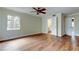 Well-lit bedroom with wood-look floors, neutral walls, and a bathroom doorway visible at 2901 Pelham Rd N, St Petersburg, FL 33710