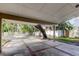 Covered carport with brick-patterned pavement and a view of lush greenery at 2901 Pelham Rd N, St Petersburg, FL 33710