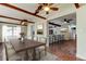 Elegant dining room with a large table, brick floors, and views into the updated kitchen at 2901 Pelham Rd N, St Petersburg, FL 33710
