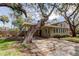 Attractive house with a driveway surrounded by mature trees and foliage at 2901 Pelham Rd N, St Petersburg, FL 33710