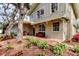 Charming two-story home with inviting front porch, flowering plants, and landscaped garden at 2901 Pelham Rd N, St Petersburg, FL 33710