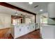 Well-lit kitchen with a large island featuring white cabinets, stainless steel appliances, and brick flooring at 2901 Pelham Rd N, St Petersburg, FL 33710