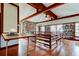 Spacious living room with hardwood floors, exposed beams and a large brick fireplace at 2901 Pelham Rd N, St Petersburg, FL 33710