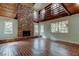 Spacious living room showcasing a floor-to-ceiling brick fireplace and bright natural light at 2901 Pelham Rd N, St Petersburg, FL 33710