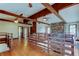 Large living room with wooden beams, a brick fireplace, and hardwood floors at 2901 Pelham Rd N, St Petersburg, FL 33710