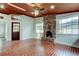 Spacious living room showcasing brick flooring, a brick fireplace, and a wood-paneled ceiling at 2901 Pelham Rd N, St Petersburg, FL 33710