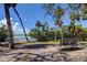 Park bench offering serene views of the water and lush green trees, ideal for relaxation at 2901 Pelham Rd N, St Petersburg, FL 33710