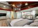 Bedroom with a loft area above, wood-paneled ceiling, hardwood floors, and bright natural light at 2901 Pelham Rd N, St Petersburg, FL 33710