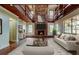 Living room featuring a grand brick fireplace, light colored furniture, and a decorative rug at 2901 Pelham Rd N, St Petersburg, FL 33710