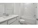 Modern bathroom featuring a tub, shower, and vanity with stone countertops and white cabinets at 3980 Big Sky Dr, Spring Hill, FL 34604