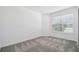 Well lit bedroom with large window, plush carpeting and neutral color palette at 3980 Big Sky Dr, Spring Hill, FL 34604